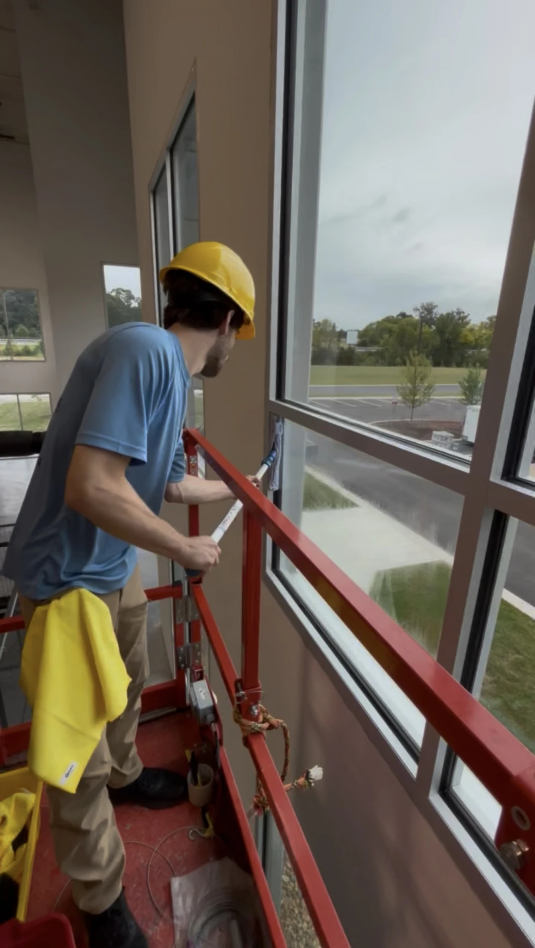 Window cleaner washing large exterior glass panels